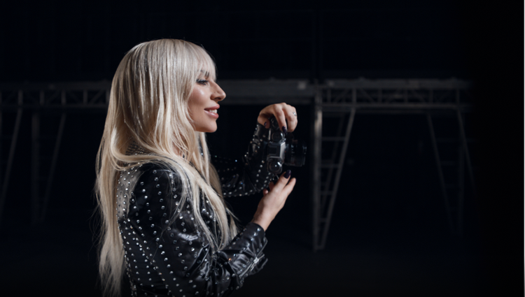 Actual Nurtec® ODT (rimegepant) patient Lady Gaga holding a camera