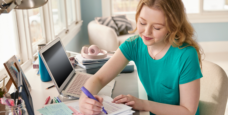 Ellie, an actual Nurtec ODT (rimegepant) patient, is shown at a desk in her home office.