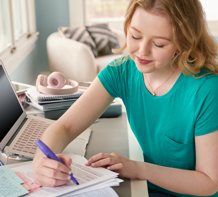 Ellie, an actual Nurtec ODT (rimegepant) patient, is shown at a desk in her home office.